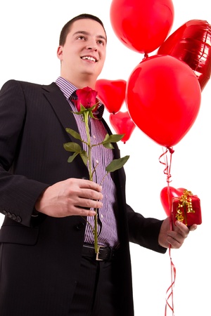 romantic guy with red rose and heart shaped balloons.の写真素材