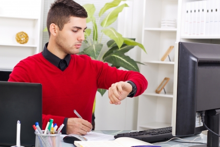 business men looking at hiis watch,and watch the timeの写真素材