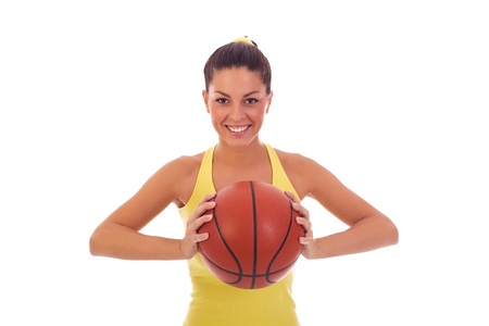 Athletic woman with a basketball in her handsの写真素材