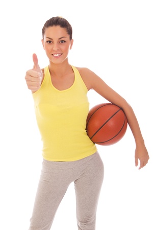 young attractive sporty woman holding a basket ballの写真素材