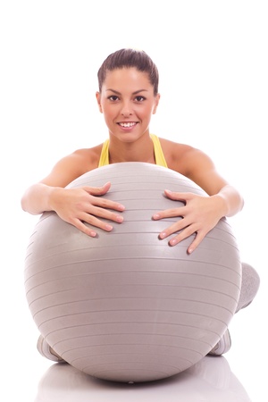  beautiful sport woman hugging big gray ballの写真素材