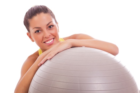 Portrait of pretty young woman holding fitness ball の写真素材