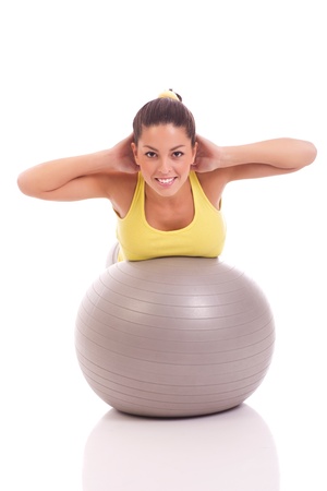 woman exercising on the big gray ballの写真素材