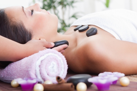  attractive woman getting spa treatment with massage stonesの写真素材