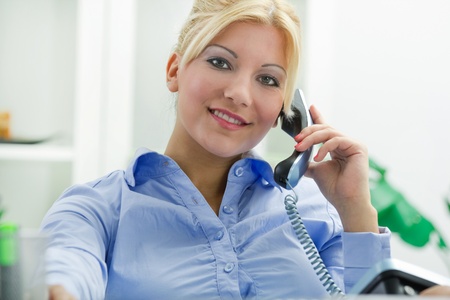 young bussines woman in office using telephoneの写真素材