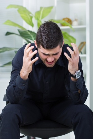 nervous businessman yelling, worried about jobの写真素材