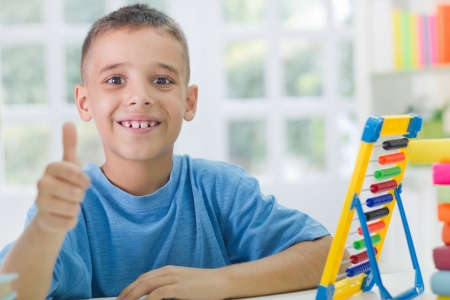 happy school boy with thumb upの写真素材