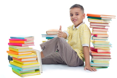 boy siting on floor surrrounded with booksの写真素材