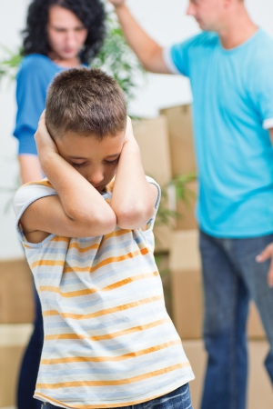 young boy agonizes while parents fighの写真素材