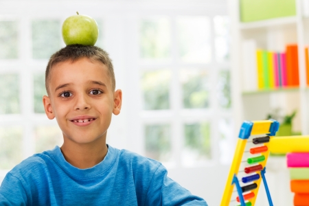 child playing with apple on worktableの写真素材