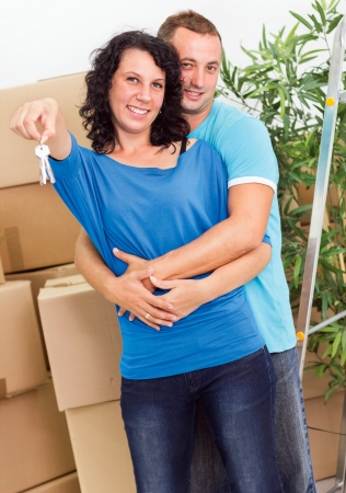 Young smiling couple  with keys to the apartmentの写真素材
