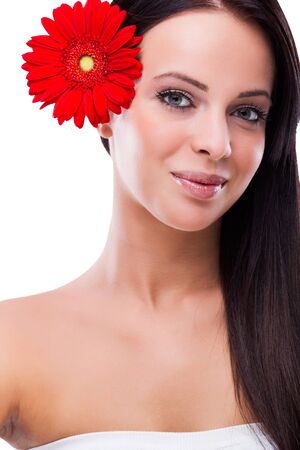Beautiful woman with red flower in her hairの写真素材