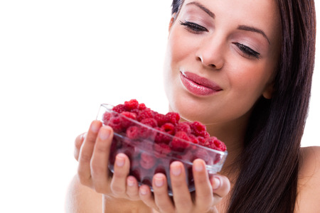  Beautiful woman holding a pot of raspberriesの写真素材