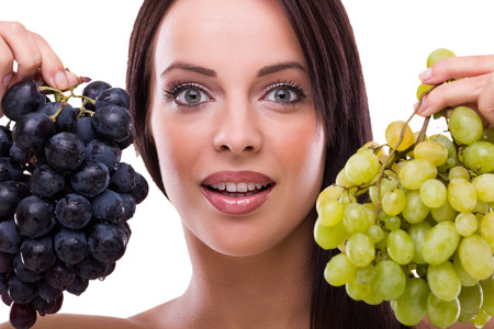 Beautiful woman holding fresh grapes の写真素材