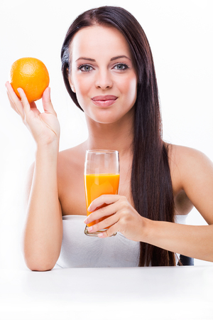  Beautiful young woman holding orange and orange juiceの写真素材