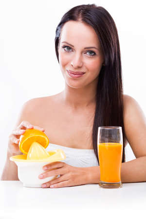 Beautiful woman with a juicer and orangesの写真素材