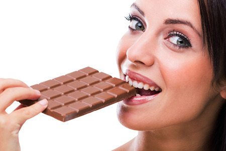 Beautiful girl eating chocolateの写真素材