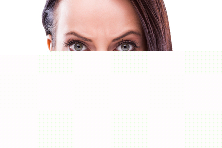 Beautiful young woman smelling pepperの写真素材