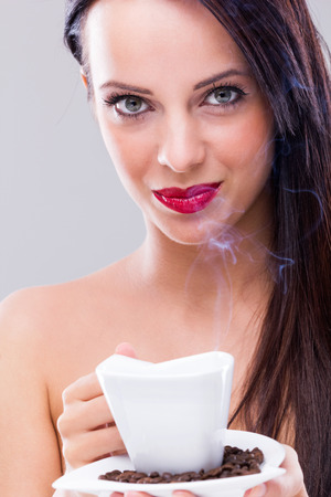 Beautiful woman drinking hot coffeeの写真素材