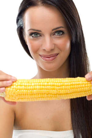 woman holding a peeled corn cobの写真素材