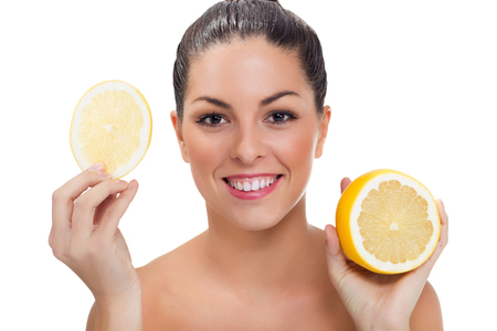 Beautiful woman with half of lemonの写真素材