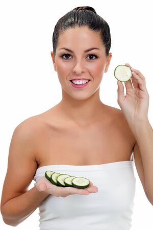 woman holds in her hand sliced ââcucumbers, makeup and healthy life conceptの写真素材