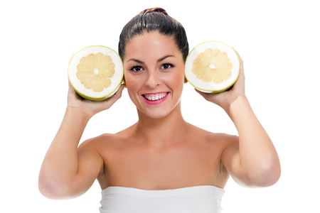 woman holds in her hand a large grapefruitの写真素材