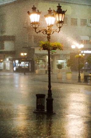photo of an old street lamppost in the rainの写真素材