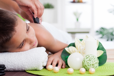  young boy  relaxing in spa. stone massage. の写真素材