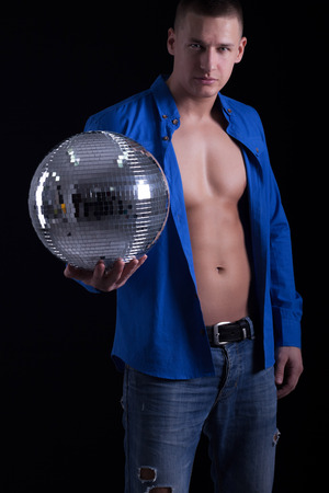 young caucasian sexy muscled attractive handsome man with disco ballの写真素材