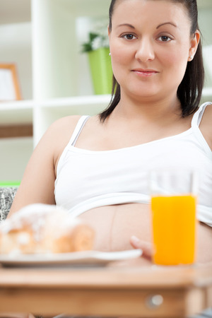 portrait of pregnant woman at homeの写真素材
