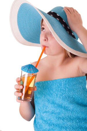 Beautiful little girl in summer hat drinking juiceの写真素材