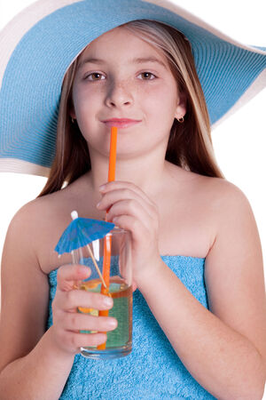 Beautiful little girl in summer hat drinking juiceの写真素材