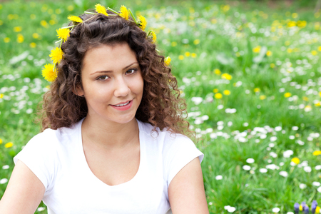 beautiful young girl in flower fieldの写真素材