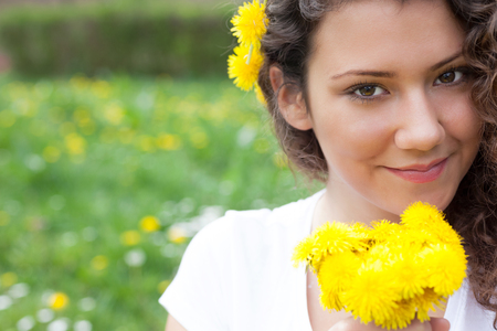 Portrait of the young beautiful smiling woman outdoors の写真素材