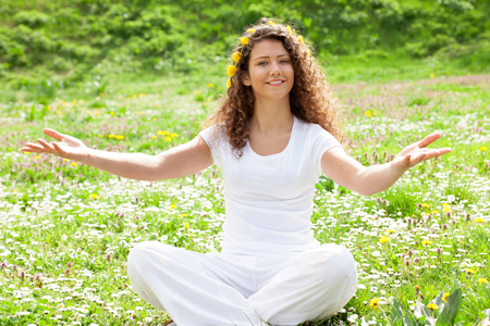 Portrait of the young beautiful smiling woman outdoors in natureの写真素材