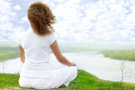 Young girl in lotus poseの写真素材