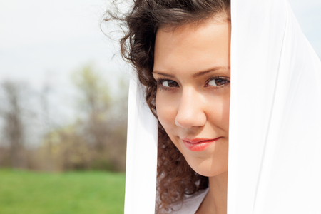 Portrait of the young beautiful smiling woman outdoorsの写真素材