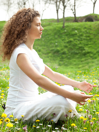 Attractive girl in one of the yoga postures close upの写真素材