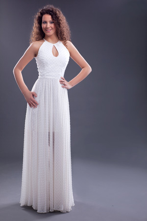 Beautiful smiling elegant woman in white dressの写真素材