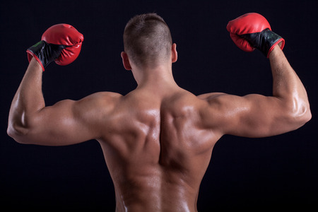 Boxer man  with red gloves showing his back の写真素材