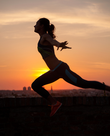  Girl streching at Sunrise or Sunset の写真素材