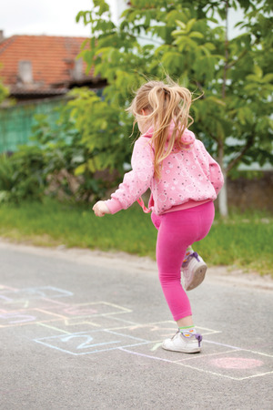 beautiful litlle girl on the hopscotchの写真素材