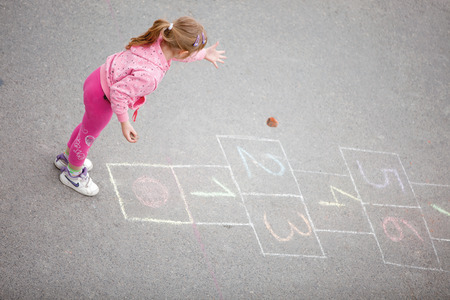 beautiful little girl on the hopscotchの写真素材