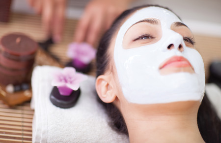 beautiful woman having facial mask at beauty salonの写真素材