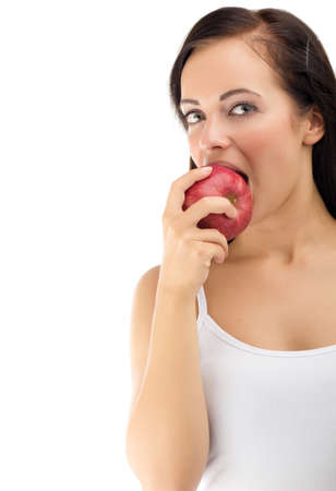 Beautiful young woman eating apple の写真素材