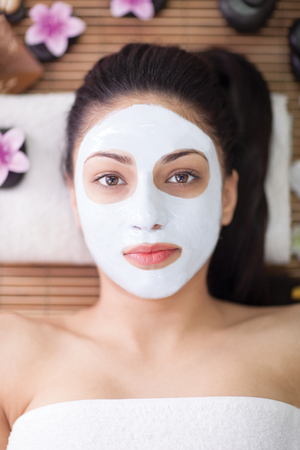 beautiful woman having facial mask at beauty salonの写真素材