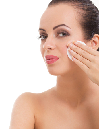 woman removing face makeup with cotton swab padの写真素材