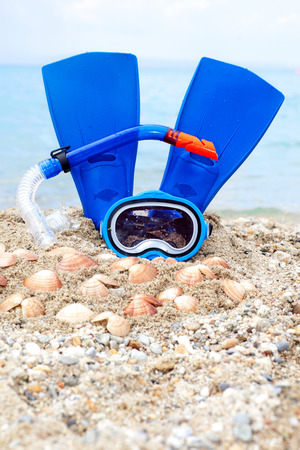Mask and flippers on a sand beachの写真素材