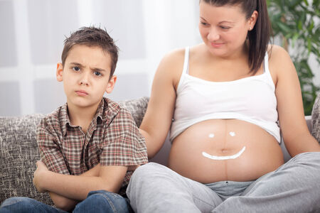 Young boy not happy about a new sibling の写真素材